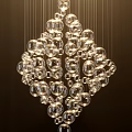 Modern Elegant Chandelier with Transparent Glass Balls Hanging Under Light Glow
