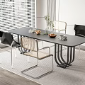 Modern Black Dining Table Set With Mixed Chairs And Green Plant On Wooden Floor