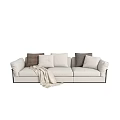 Modern Beige Three-Seater Sofa with Brown and White Pillows and Cozy Blanket