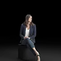 Professional Woman In Navy Blazer White Top And Blue Jeans Sitting On Black Cube