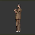 Child In Brown Suit Giving Thumbs Up With Smile On Grey Background