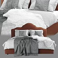 Textured Fabric Upholstered Brown Headboard Bed With Gray Pillows And Blanket