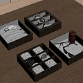 Black Jewelry Boxes With Compartments Holding Watches Necklaces Bracelets And Eyeglasses On Wooden Tabletop