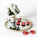 White Flowers In Ceramic Vase On Round Gold Glass Tray With Red Lotus Decorations
