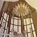 Sacred Church Interior With Elegant Chandeliers Floral Arrangements And Worship Altar