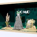 MOCO Window Display Featuring Elegant Dress With Decorative Plants And Green Backdrop