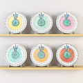 Colorful Decorative Plates With Fruit Slice Patterns Arranged On Wooden Shelves And Blue Edges