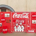 Coca Cola Red Wall Display With Chinese Brand Characters Bear Mascots And Product Boxes
