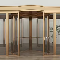 Elegant Golden Frame Revolving Door With Glass Panels And Wooden Floor