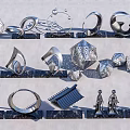 Various Metal Sculptures with Geometric Shapes and Human Forms on Black Slate Bases