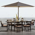 Outdoor Table with Umbrella and Chairs Featuring Sea View and Decorative Centerpiece