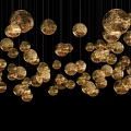 Golden Chandelier with Small Crystal Beads Arranged in Moon Shaped Design Against Black Background