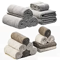 Soft Absorbent Cotton Towels in Various Colors Rolled and Stacked Neatly