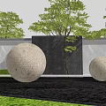 Circular Stone Landscape Sculptures in Garden with Water Feature Grass Trees and Gray Black Wall