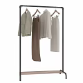 Stylish Beige Knit Sweaters With Brown Pants Hanging On Metal Clothing Rack