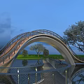 Modern Arched Landscape Bridge With Metal Railings Over Water And Tree Reflections