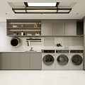 Modern Laundry Room Interior With Three Washing Machines White Countertops Gray Cabinets And Plants