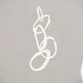 Modern White Chandelier with Curved Lines Design Hanging Against Gray Wall