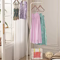 Elegant Bedroom Interior With Clothing Rack Colorful Dresses Green Plant And Decor Items