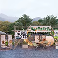 Outdoor Photo Check-in Spot With Wooden Pergola Mountain Backdrop Trees Tables Chairs And Posters