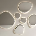 Multiple Irregular Shaped Mirrors with Illuminated Edges Mounted on White Wall