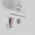 Clothes Hangers with Hanging Garments and Overhead Linear Lights in White Minimalist Space
