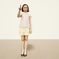 Young Girl Pointing Upward With Index Finger in Pink Short Sleeve Top Yellow Pleated Skirt
