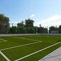 Football Field With Green Artificial Turf White Markings Goalpost And Trees Around Fence