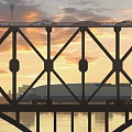 Steel Truss Bridge Carries Cars And High Speed Train At Golden Sunset Over Calm River