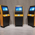 Public Facility Three Yellow And Black Self Service Kiosks With Screen Displays
