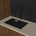 Black Kitchen Sink With Silver Faucet On Light Colored Countertop And Wooden Cabinets