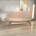 Modern Living Room Beige Ottoman On Wooden Floor With Green Plant Artwork And Floor Lamp