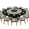 Round Wooden Dining Table With Twelve Light Colored Chairs And Green Plant Centerpiece
