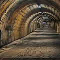 Stone Arch Tunnel Interior With Paved Floor Graffiti Walls And End Light