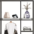 Fashionable Clothes Display With Racks Hanging Black White Gray Garments And Bags Shoes