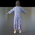 Woman In Blue Purple Floral Long Sleeve Dress Standing With Arms Outstretched On Gray Background