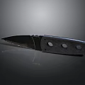 Sharp Folding Knife With Two Circular Holes On Handle And Metal Reflective Surface
