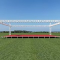 Outdoor Event Stage Featuring White Metal Frame Red Floor Green Grass And Blue Sky