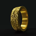 Exquisite Golden Ring With Intricate Textured Surface And Sleek Band Design
