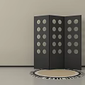 Black Three Panel Room Divider With Circular Cutouts And Round Patterned Rug