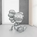 Metallic X Eyed Modern Doll In Minimalist Indoor Setting With Gray Wall And Blinds