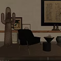 Black Upholstered Leisure Chair With Gold Legs Near Side Table Glass Cactus And Wall Art