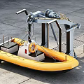 Industrial Equipment Featuring Yellow Inflatable Boat Lifting Mechanism And Metal Platform