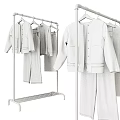 Stylish Beige Knit Sweaters With Brown Pants Hanging On Metal Clothing Rack