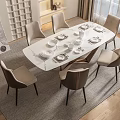 Modern White Dining Table Set With Six Beige Chairs Black Legs And Tableware On Rug
