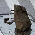 Serene Garden Landscape With Natural Stone Fountain Flowing Water And Paved Surroundings