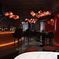 Modern Bar Interior With Red Pendant Lights Black Bar Stools And Orange Lit Counter