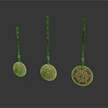 Three Copper Spoons With Wooden Handles And Decorative Patterns In Different Sizes