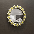 Circular Mirror With Decorative Yellow And White Beads Reflecting Bedroom Bed And Pillows