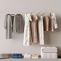 Hanging Clothes In Neutral Tones With Folded Items In Minimalist Interior